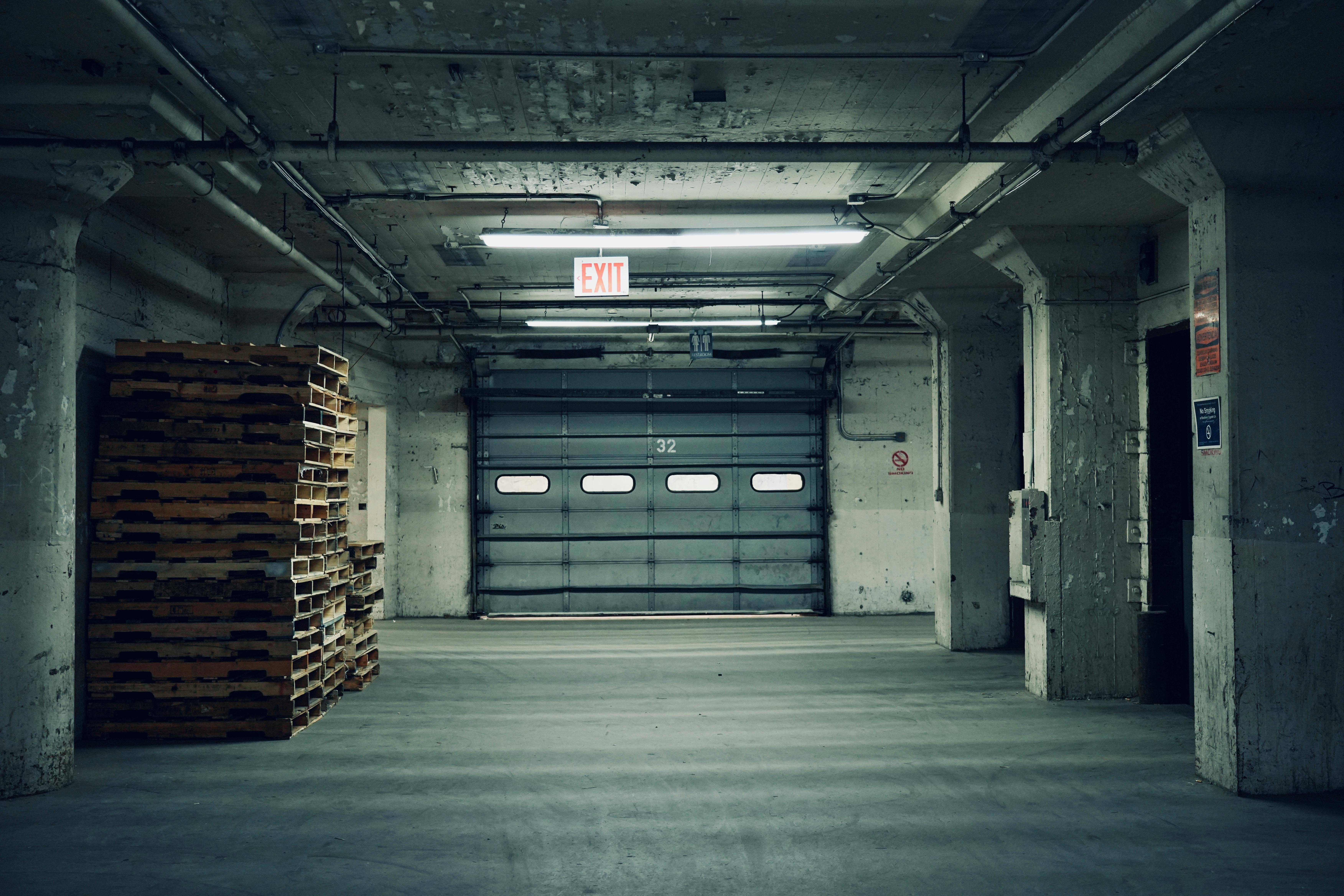 Professional garage door technician working on industrial door